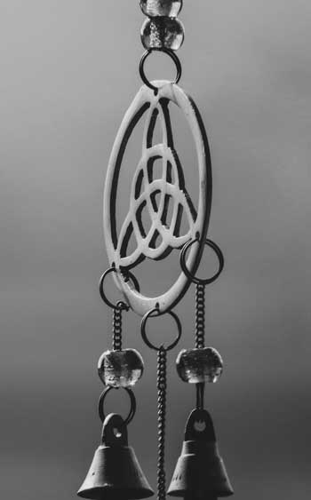 Celtic knot design with hanging bells and handcrafted detail