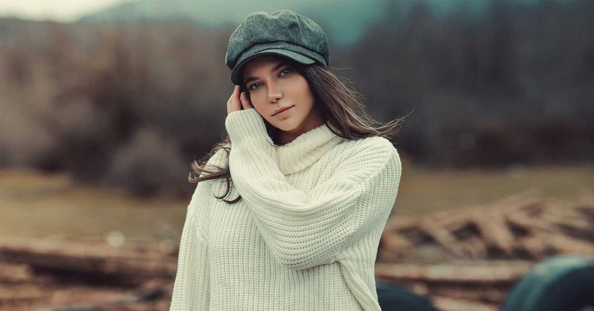 Irish Aran sweater and tweed cap worn outdoors in a natural setting showcasing traditional Irish clothing style