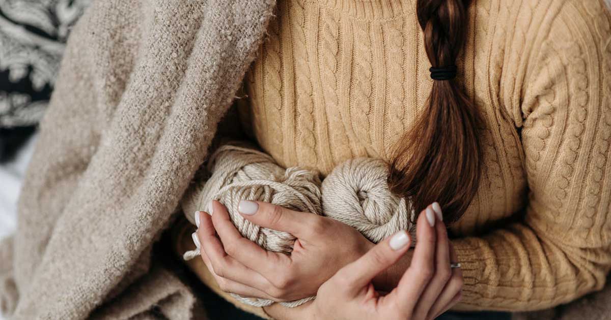 Irish wool sweater with traditional cable knit pattern and natural yarn