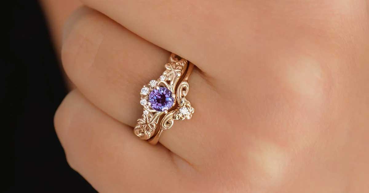 Irish Celtic engagement ring with gemstone and gold band worn on hand